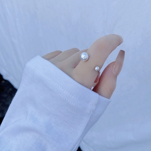 Close-up of minimalist adjustable S925 silver ring with dual white round pearls