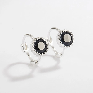 Close-up of 925 sterling silver hoop earrings featuring micro-set black cubic zirconia