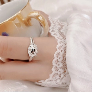 Close-up of S925 sterling silver flower crown ring on finger with lace cuff detail