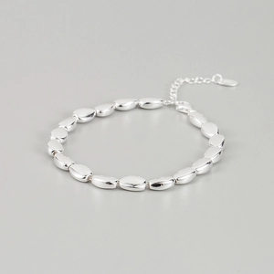 Macro shot of polished S925 sterling silver bead bracelet with adjustable chain extension