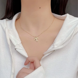 Minimalist S925 sterling silver palm tree pendant necklace in gold on a model