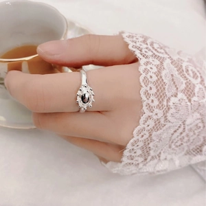 Close-up of S925 sterling silver oval crown ring with retro bead texture on a finger