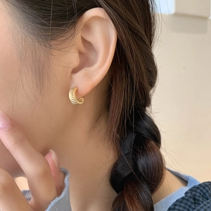 Elegant gold S925 silver corrugated gear hoop earrings with textured finish on ear