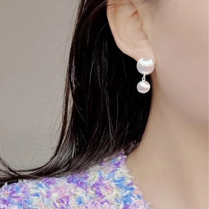 Close-up of S925 sterling silver earrings with a double disc matte brushed texture