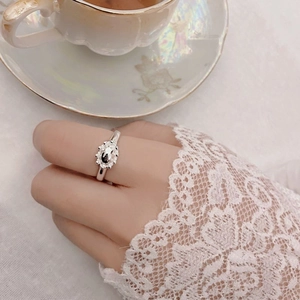 Elegant S925 sterling silver crown ring with oval crystal on a vintage background