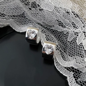 Detailed close-up of S925 silver heart hoop earrings with sparkling zircon on lace