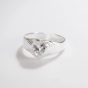 Macro shot of silver S925 heart-shaped zircon ring with layered texture and open band