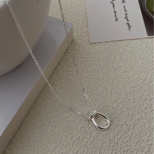 Minimalist 925 sterling silver knot necklace with U-shaped pendant on white background