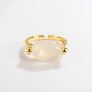 Macro detail of S925 hallmark on minimalist gold-plated silver ring with white stone