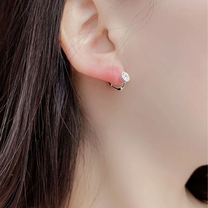 Close-up of S925 sterling silver stud earring with a brilliant round-cut zircon on ear