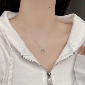 Minimalist 925 sterling silver knot pendant necklace worn on a casual hoodie