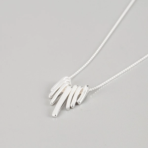 Detail of silver S925 necklace featuring a geometric fringe bar pendant in a minimalist style