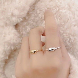 Detailed view of gold and silver S925 sterling silver twist rings with wish engraving