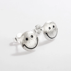 Detailed macro view of S925 sterling silver earring featuring brushed finish and smile face