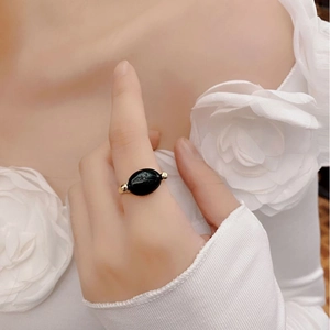 Close-up of minimalist 925 silver ring with black onyx stone on female finger