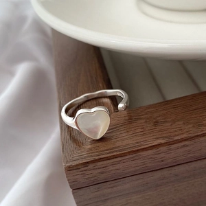 Close-up of S925 sterling silver heart ring with white shell inlay and hallmark