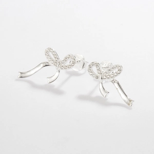 Macro view of S925 sterling silver hallmark on ribbon bow earrings with micro-inlaid zircons