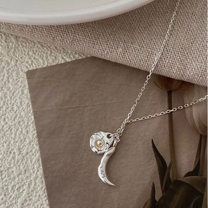 Detailed macro of S925 sterling silver stamp on the pearl and crescent moon necklace