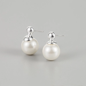 Macro shot of 925 sterling silver pearl stud earrings showing the S925 hallmark