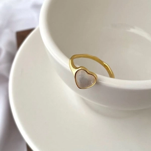 Macro shot of S925 sterling silver heart ring with white shell inlay and gold plating