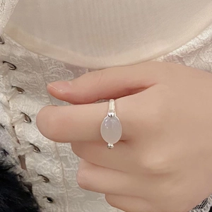 Close-up of 925 sterling silver ring with white chalcedony on lace background
