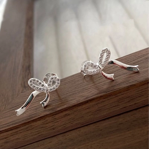 Sparkling S925 sterling silver bow earrings featuring pavé cubic zirconia ribbon design