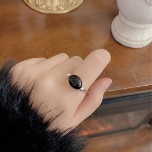 Minimalist S925 silver ring featuring oval black onyx stone on vintage background