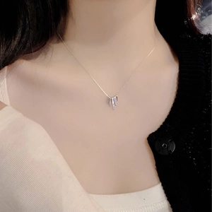 Close-up of S925 sterling silver geometric fan fringe pendant on model neckline
