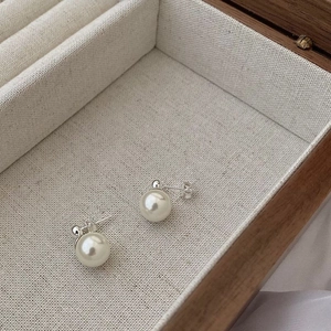 925 Sterling Silver Pearl Stud Earrings displayed on a wooden jewelry box