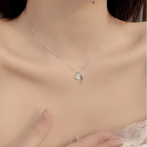 925 silver crescent moon and pearl pendant necklace elegantly worn on a model's neck