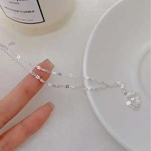 Close-up of S925 sterling silver chain with unique four-leaf clover shaped links