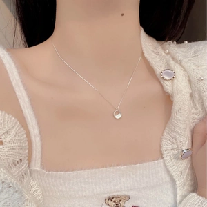 Close-up of minimalist 925 sterling silver necklace with square Miss engraved pendant