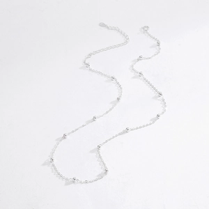 Minimalist S925 sterling silver beaded choker necklace with a heart tag on white background