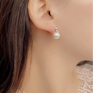 Macro view of a 925 silver pearl stud earring with elegant high-luster finish