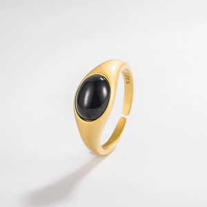 Detail of matte gold S925 sterling silver ring featuring a smooth black onyx gemstone inlay