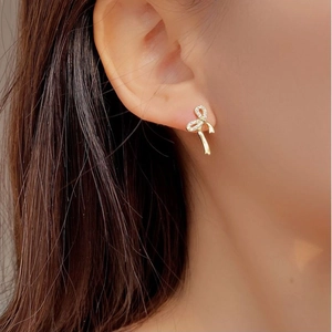 Sparkling S925 sterling silver bow ribbon earrings with micro-set cubic zirconia on ear