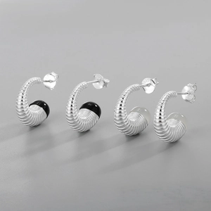 Gros plan du poinçon S925 sur les boucles d'oreilles en argent et agate à motifs filetés