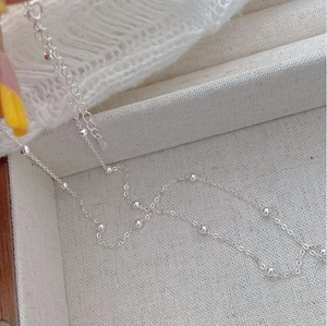 Detailed macro of S925 sterling silver beaded choker necklace with lobster clasp