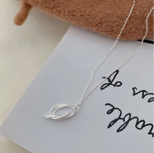 Macro shot of S925 sterling silver minimalist geometric pendant with layered rings