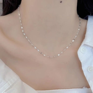 Close-up of S925 sterling silver lip-link chain necklace on model neck with white shirt