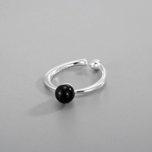 Macro shot of S925 sterling silver ring showing internal hallmark and black onyx bead
