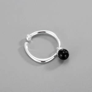 Detail of adjustable S925 silver ring featuring a polished black agate bead accent