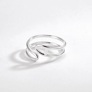 Macro detail of silver minimalist double-layer ring featuring a central H-link design