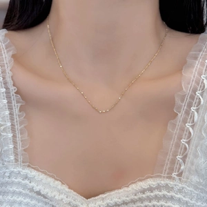 Detail of S925 sterling silver necklace featuring geometric cube beads on a thin gold chain