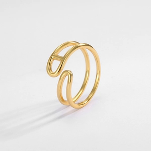 Close-up of golden double-layer ring with H-shaped hollow design and polished finish