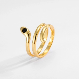 Detail of a vintage golden snake ring with double spiral design and a black gemstone