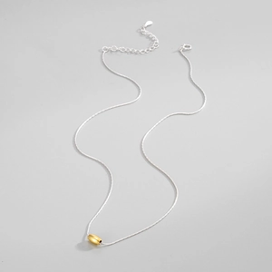 Close-up of S925 silver clasp and polished gold oval bead on minimalist chain