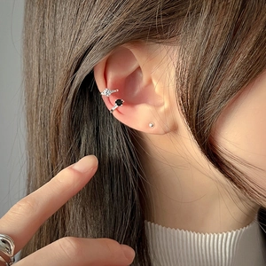 Detail view of S925 sterling silver ear cuffs set with white and black zircon stones