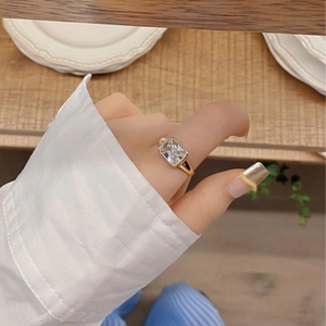Close-up of a S925 silver ring with a large rectangular zircon on a person's finger