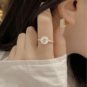 Detailed macro view of S925 sterling silver ring with yellow zircon on a finger